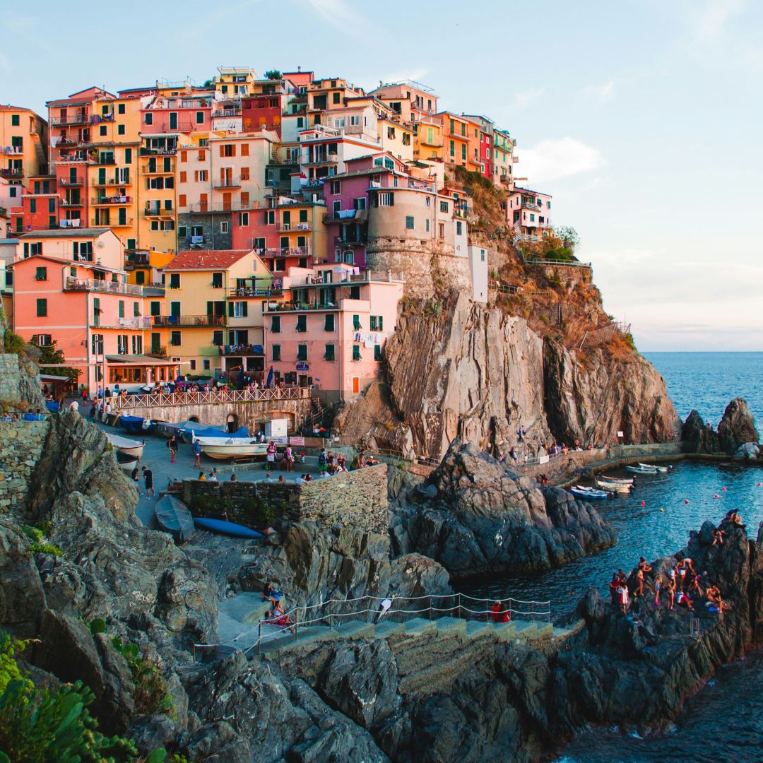 Overlooking Amalfi coast with coloured building lining the cliff and walkway down to the sea