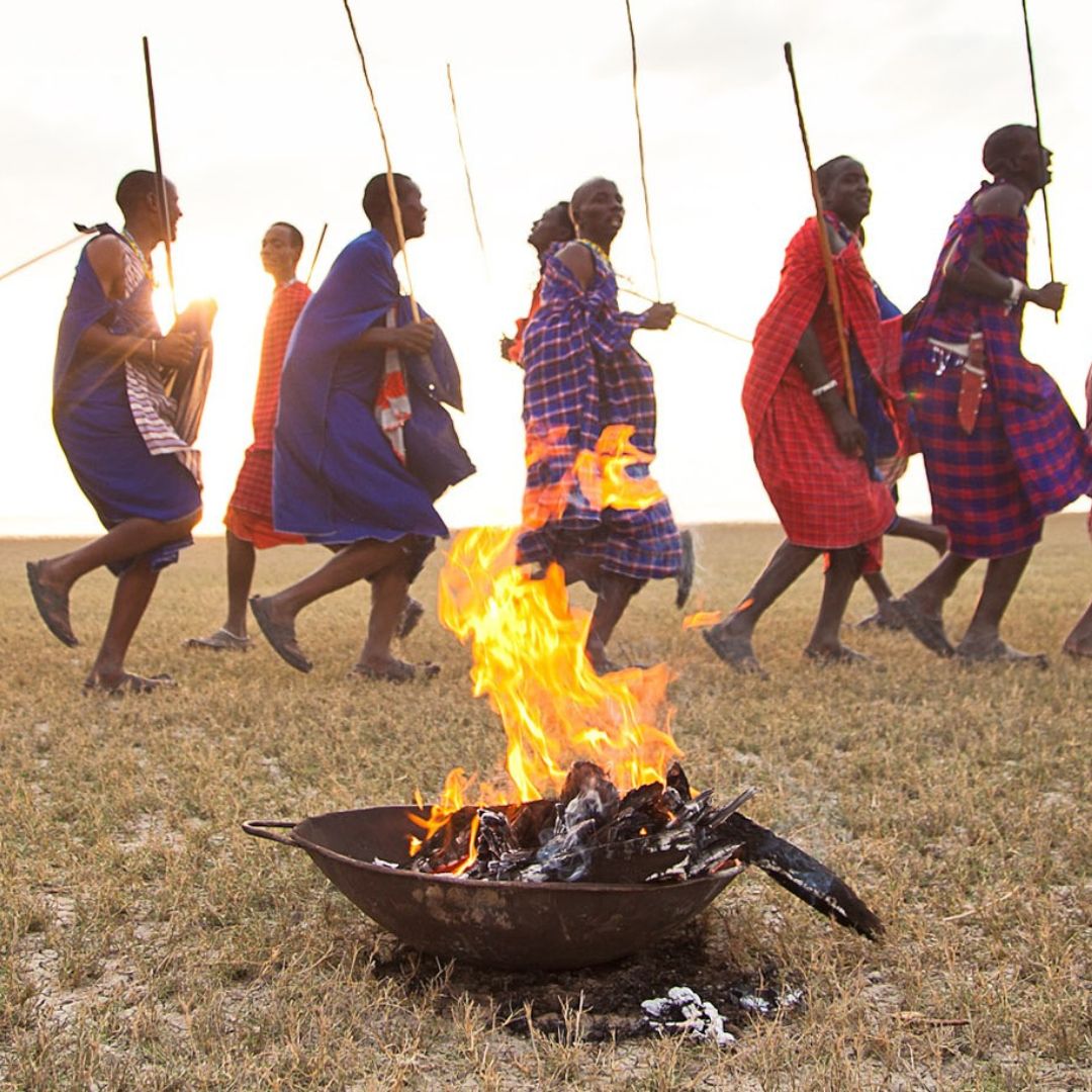 Maasai tribe around a burning fire pit