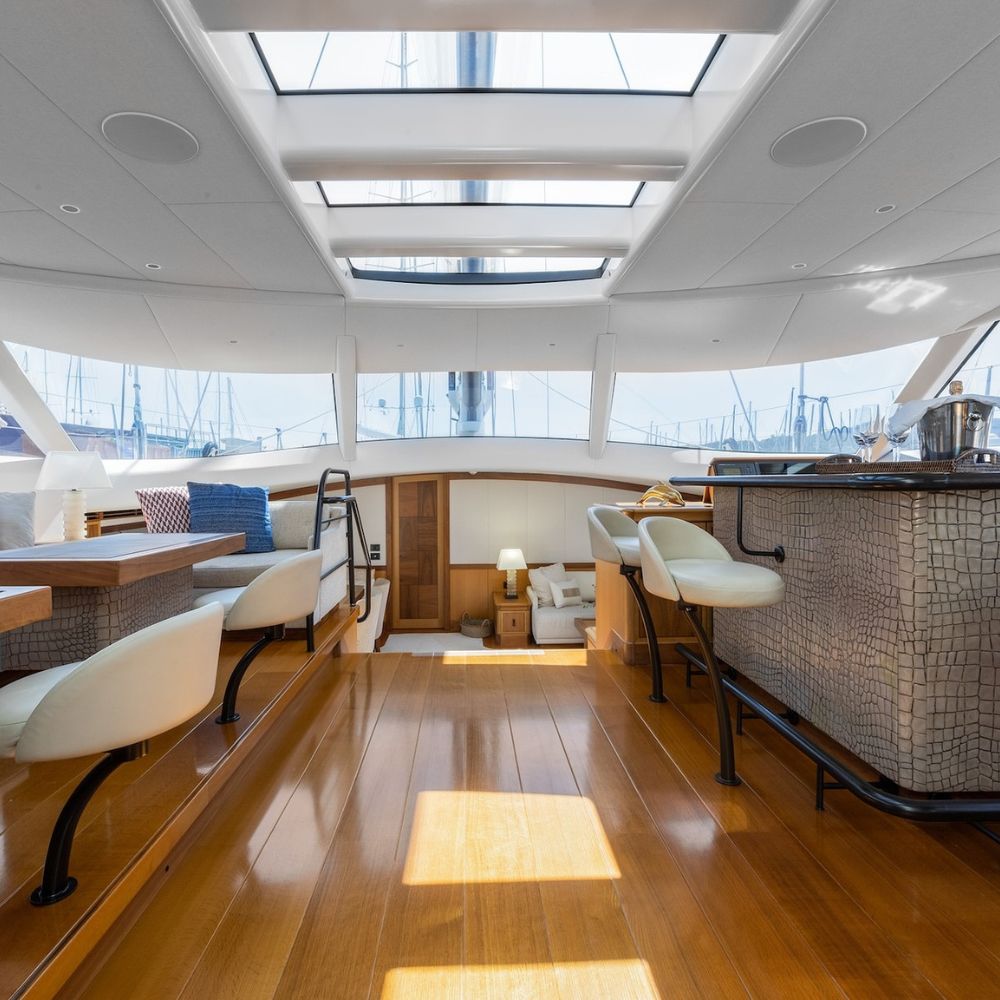 Elegant sailing yacht deck with bar, skylights, and dining setting – Pelorus Yachting 2026 luxury sailing exploration.