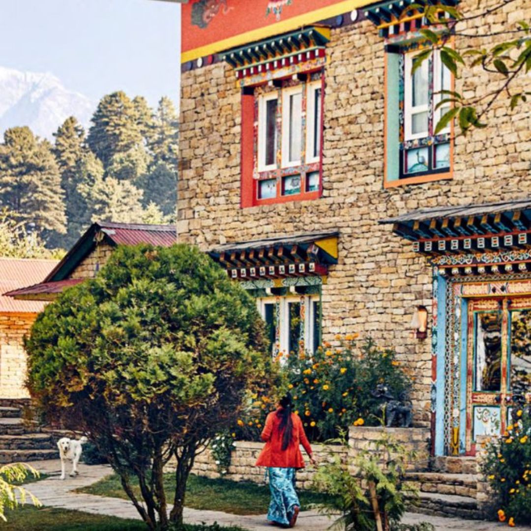 Woman walking outside the Happy House Nepal with a dog