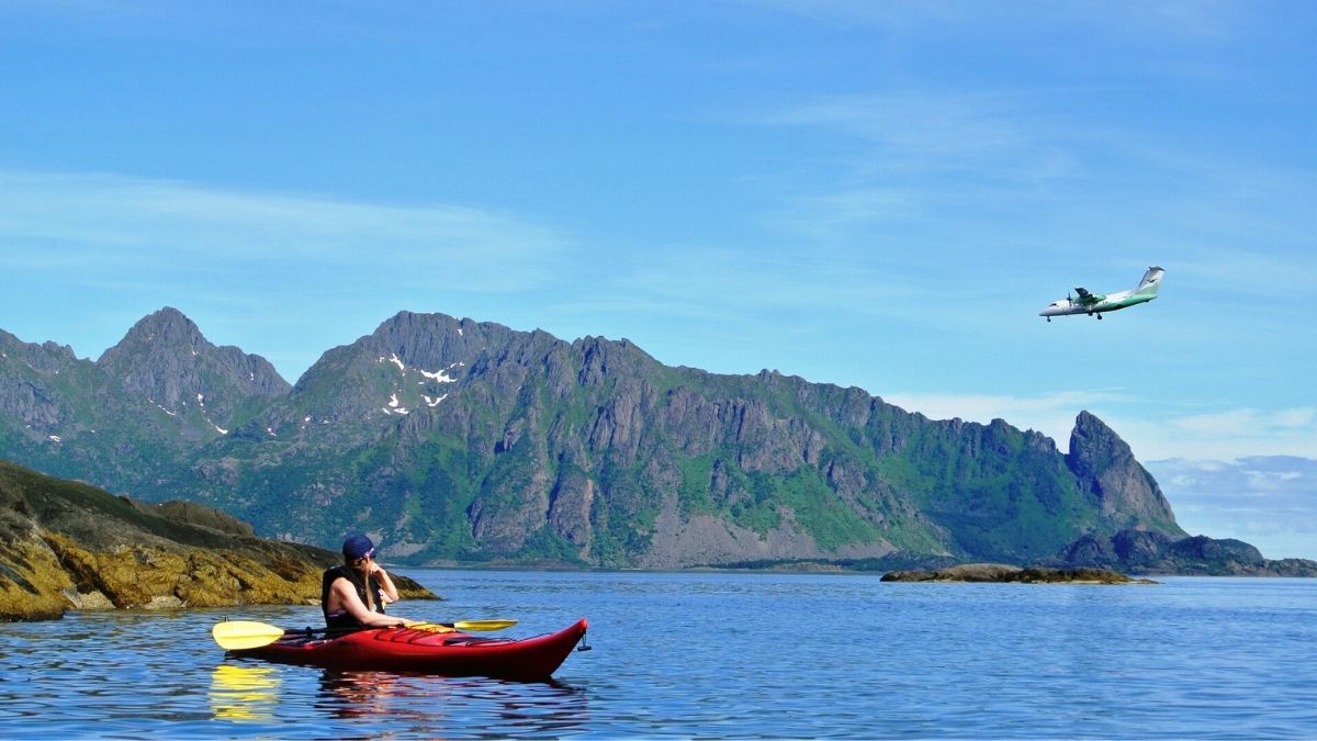 Kayaking on the fjords in Norway with a plane flying overhead