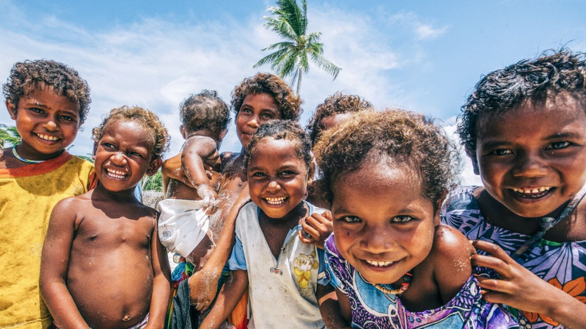 Guests learning everyday Tok Pisin while visiting coastal communities in Papua New Guinea