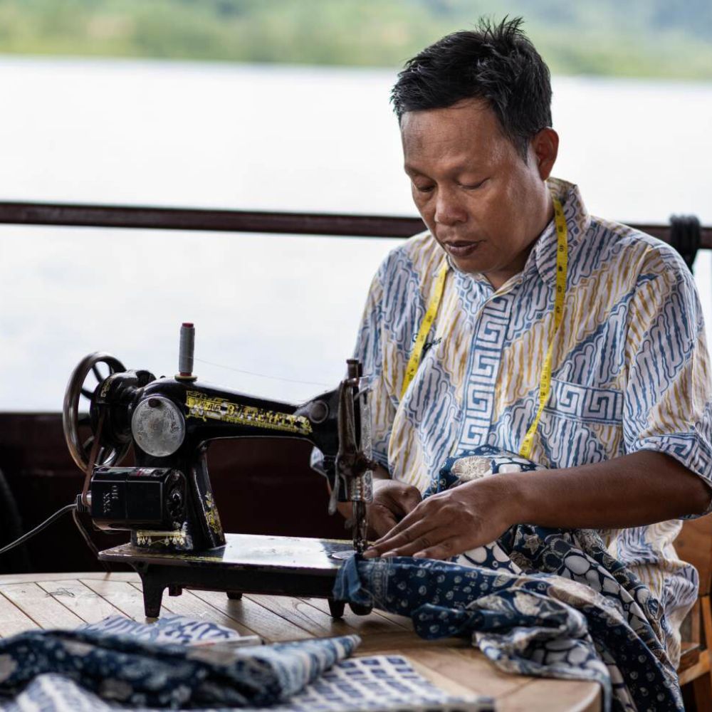 Guests learning traditional ikat sewing in Indonesia from the local community