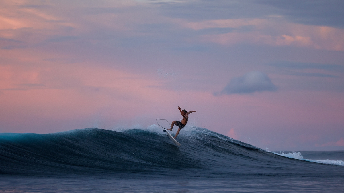 Surfer riding a perfect right-hander off the Mentawai Islands, Indonesia, accessed by private surf charter yacht SILOINA