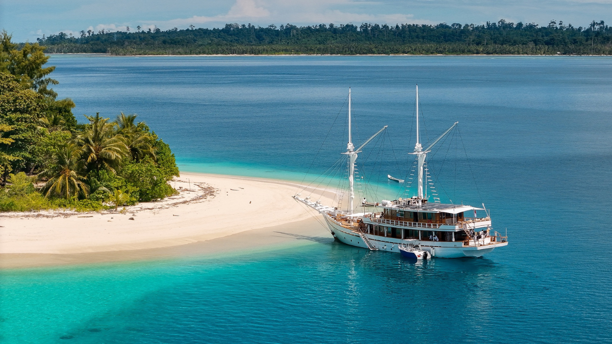 Surf tender from SILOINA delivering guests to a Mentawai Islands break at sunrise